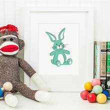 Simple bold print of a toy stuffed bunny in aqua with black accents.