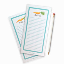 Hand illustrated carrot on lined notepad with blue border.